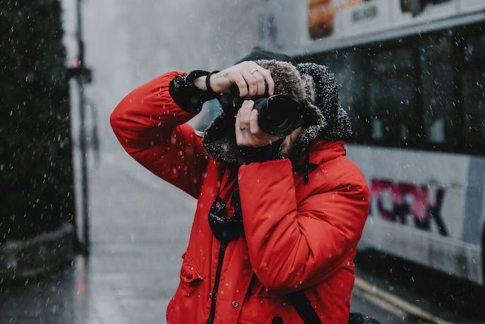 Person Taking Photo in Snowy City